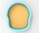 A blue bowl with a yellow substance inside, resembling a human head.