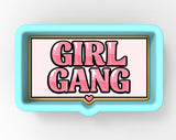 A blue rectangular tray with the text "GIRL GANG" written in pink, with a heart symbol below the text.