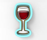 A glass of red wine is depicted in a blue and gold cookie cutter.