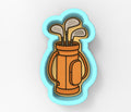 A golf bag filled with clubs, depicted in a cookie cutter shape.
