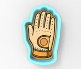 A hand wearing a glove with a hole in the palm.