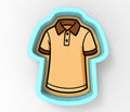 A cartoon-style illustration of a yellow polo shirt with brown sleeves, depicted in a cookie cutter shape.