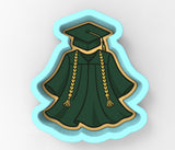 a cookie shaped like a graduation gown