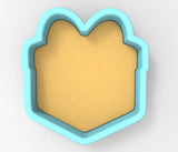 A heart-shaped cookie cutter with a light yellow interior and a blue exterior.