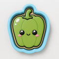 A green pepper cookie cutter with a cute face design.