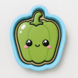 A green pepper cookie cutter with a cute face design.