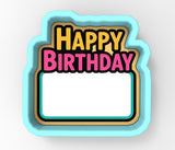 A colorful birthday cake-shaped cookie cutter with the text "Happy Birthday" displayed on it.