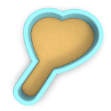a cookie shaped like a heart on a white background