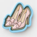 A pair of pink high-heeled shoes with bows on the toe.
