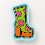 A colorful, cartoon-style shoe with a floral pattern on it.
