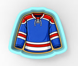 A blue and red hockey jersey with white stripes, designed as a cookie cutter.