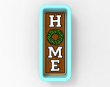 A wooden sign with the word "HOME" written on it, featuring a wreath design.