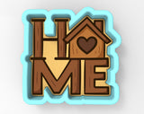 a cookie cutter shaped like the word "HOME" with a heart symbol inside it.