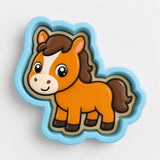 A cartoon horse cookie cutter in a blue shape.