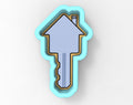 A key-shaped cookie cutter in a light blue color.