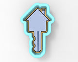A key-shaped cookie cutter in a light blue color.