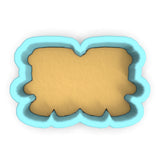 a cookie cutter with a cookie in the shape of a rectangle