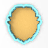 a cookie cutter with a cookie in the shape of a face