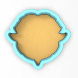 a cookie cutter with a cookie in the shape of a fish