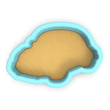 a cookie cutter with a cookie in the shape of a cloud
