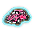 a pink car with a heart on the hood