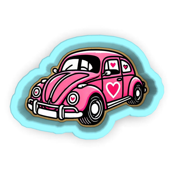 a pink car with a heart on the hood