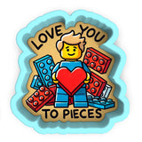 a sticker of a man holding a heart surrounded by legos