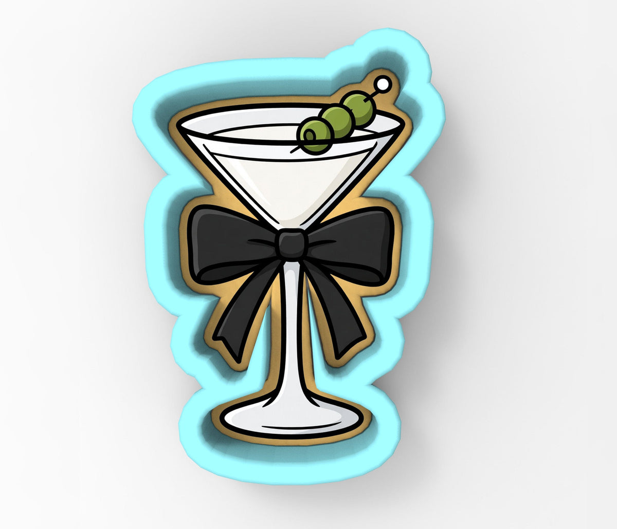A cookie cutter shaped like a martini glass with a black bow around it, and green olives on top.