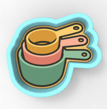 A 3D rendering of a stack of colorful measuring cups or spoons.