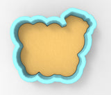 A blue-bordered cookie cutter in the shape of a cloud.