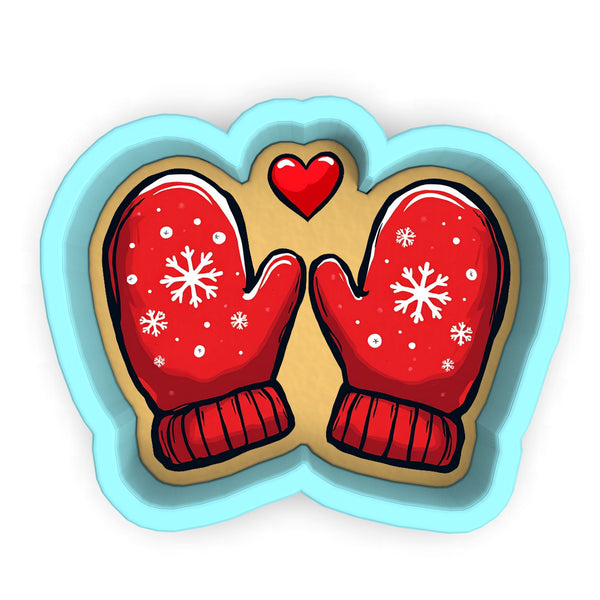 a pair of red mittens with snowflakes on them