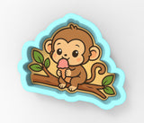 a sticker of a monkey sitting on a tree branch