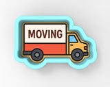 A moving truck with the word "MOVING" written on it.