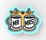 a couple of coffee mugs sitting on top of each other