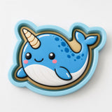 A blue cartoon narwhal with a white belly and a yellow horn is depicted in the image.
