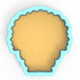 a cookie cutter with a cookie in the shape of a head