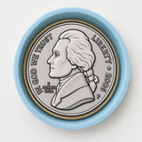 A silver coin with a profile portrait of a man, surrounded by text that reads "IN GOD WE TRUST" and "LIBERTY".