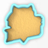 a cookie cutter shaped like the shape of a map
