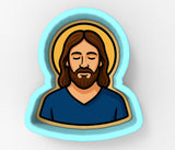 A cartoon illustration of a bearded man with a blue shirt, depicted in a circular frame.