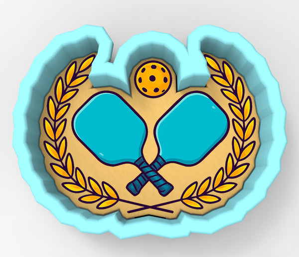 A 3D rendering of a paddleball logo, featuring two blue paddleboards crossed in an X shape, a yellow tennis ball, and a laurel wreath.