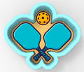 A 3D rendering of a paddleball racket with a yellow ball above it, set against a light blue background.
