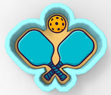 A 3D rendering of a paddleball racket with a yellow ball above it, set against a light blue background.