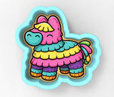 A colorful cartoon pinto pig with a pink body, yellow mane, and blue eyes, standing on a blue background.