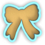 a cookie shaped like a bow on a white background
