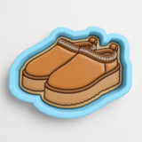 A pair of brown platform sandals with a distinctive lace-up design.