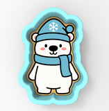 A cute cartoon polar bear wearing a blue hat with a snowflake and a blue scarf.