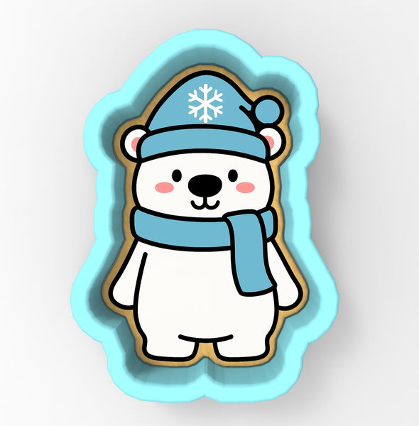 A cute cartoon polar bear wearing a blue hat with a snowflake and a blue scarf.