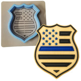 a cookie shaped like a police badge next to a cookie cutter