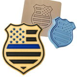 a cookie with a police badge and a cookie cutter