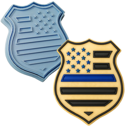 a cookie cutter and a cookie shaped like a shield